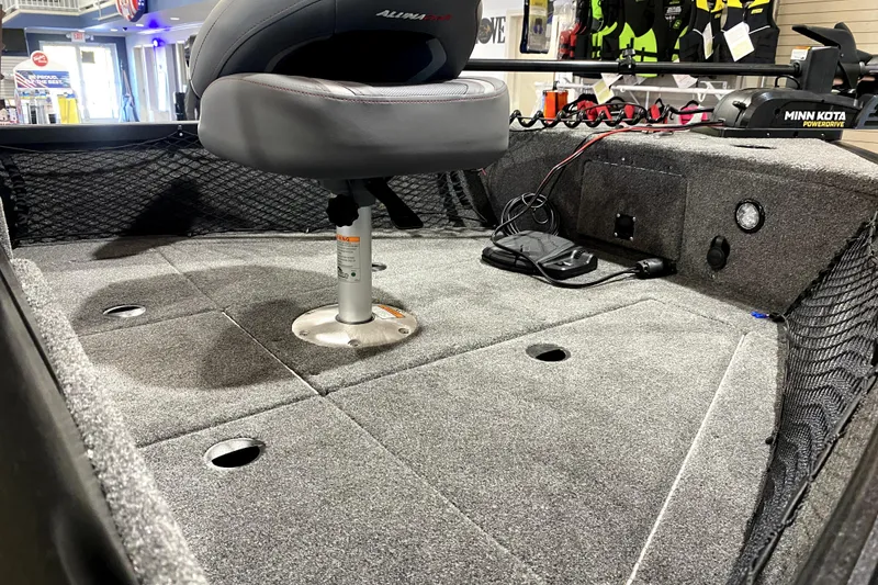 Slide: The Image of 2026 Alumacraft Voyageur 175 Sport boat interior with seating and fishing gear. - 9