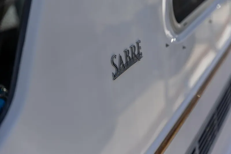 Slide: The Image of 2009 Sabre 52 Express boat exterior with logo detail. - 10