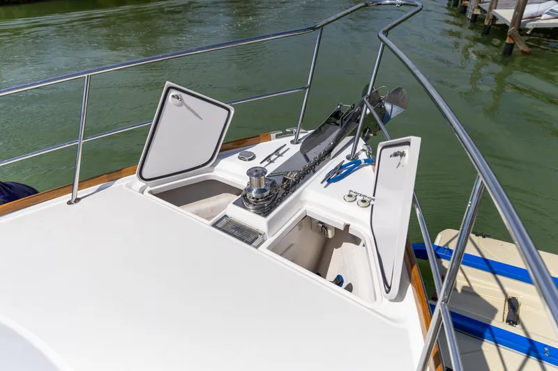 Slide: The Image of 2009 Sabre 52 Express yacht deck with open storage compartments and railing. - 11