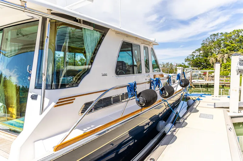 Slide: The Image of 2009 Sabre 52 Express yacht docked, showcasing sleek design and modern features. - 14