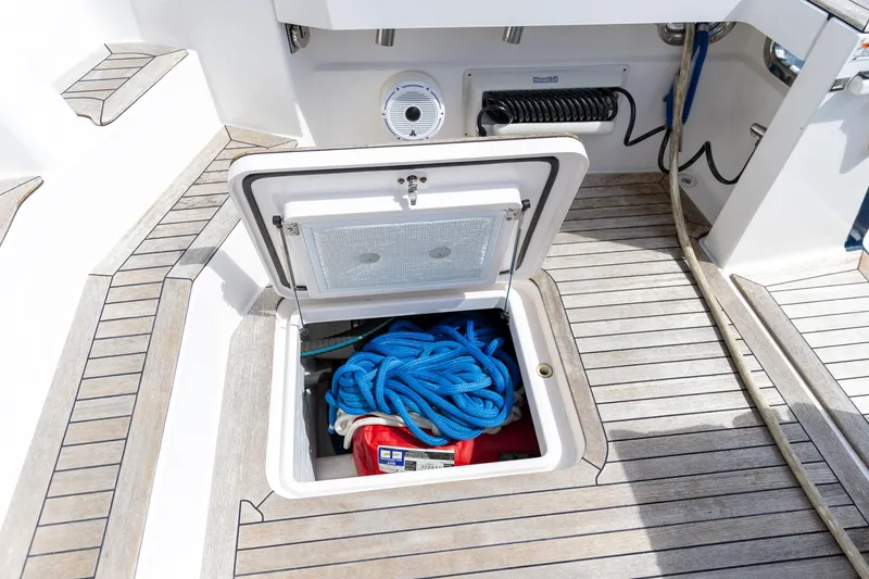 Slide: The Image of Open storage compartment on 2009 Sabre 52 Express yacht deck with blue rope. - 18
