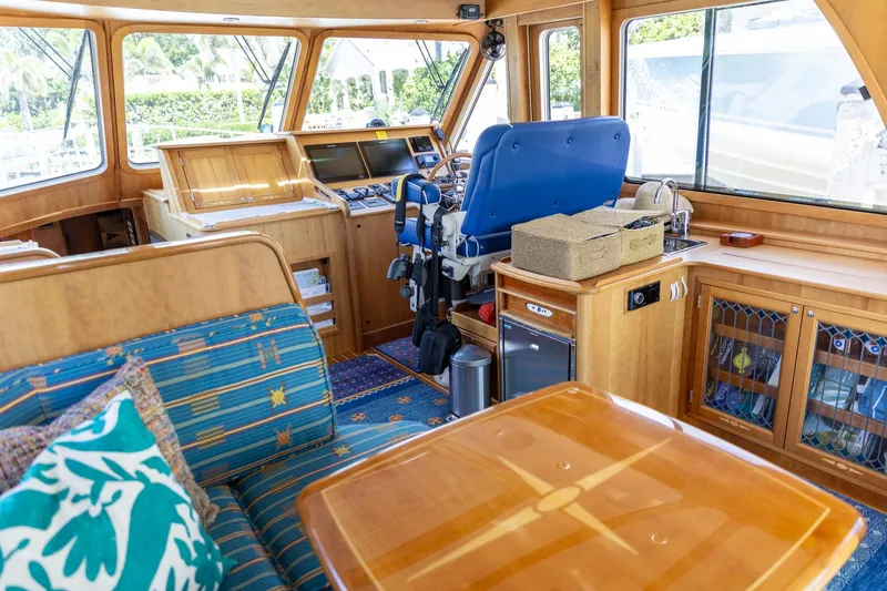 Slide: The Image of Interior of 2009 Sabre 52 Express yacht with wooden furnishings and blue seating. - 20