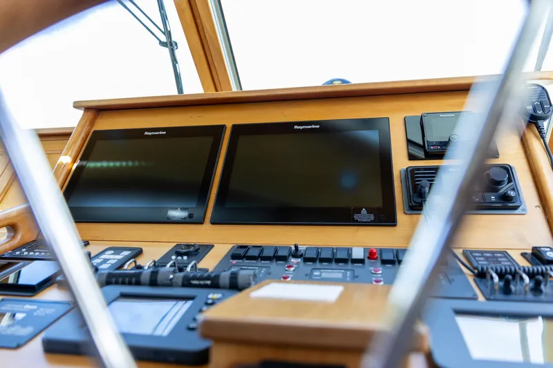 Slide: The Image of Control panel of a 2009 Sabre 52 Express yacht with navigation screens and instruments. - 23