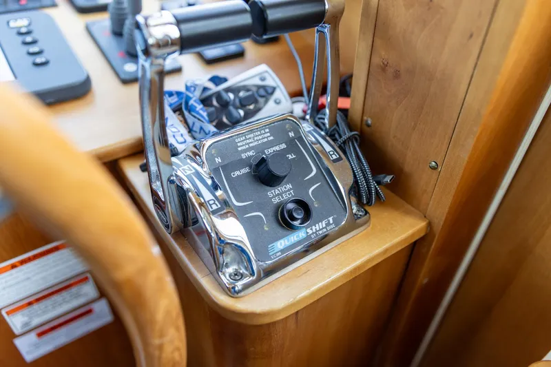 Slide: The Image of Control panel of a 2009 Sabre 52 Express boat, featuring throttle and station selector. - 25