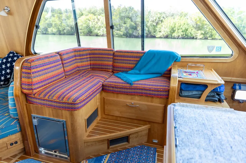 Slide: The Image of Interior of 2009 Sabre 52 Express yacht with colorful seating and scenic window view. - 27