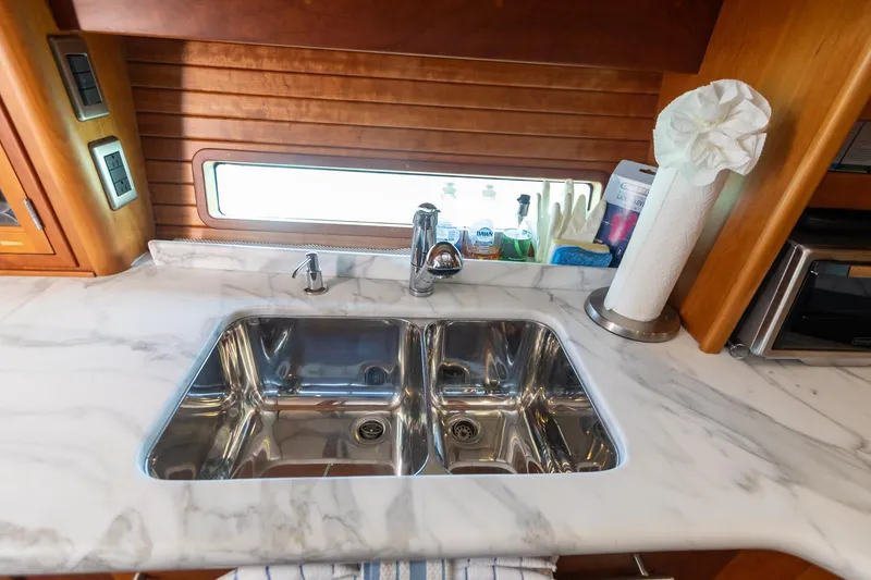 Slide: The Image of 2009 Sabre 52 Express yacht kitchen with marble countertop and double sink. - 34