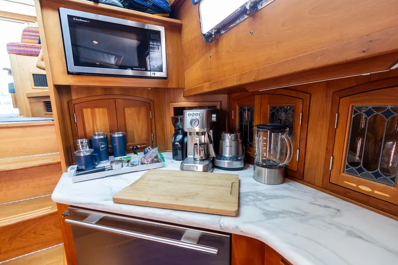 Slide: The Image of 2009 Sabre 52 Express yacht kitchen with appliances and wooden cabinetry. - 35