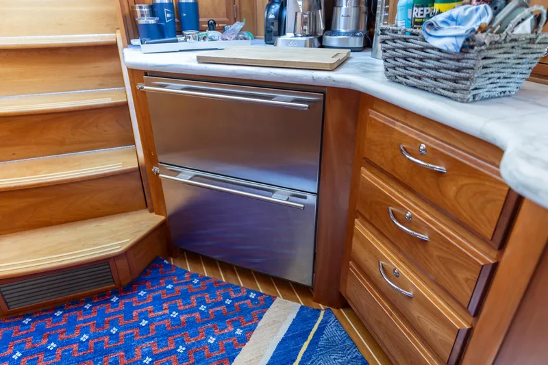 Slide: The Image of 2009 Sabre 52 Express yacht kitchen with stainless steel appliances and wooden cabinetry. - 37