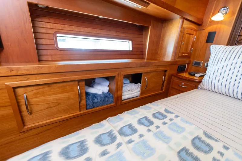 Slide: The Image of Luxurious wooden interior of 2009 Sabre 52 Express yacht cabin with storage and bedding. - 39