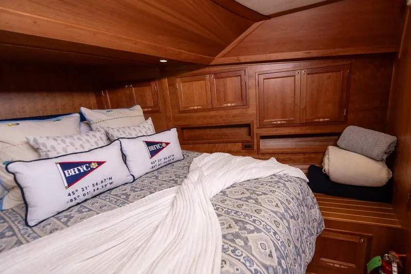 Slide: The Image of Luxurious cabin interior of 2009 Sabre 52 Express yacht with cozy bedding and wooden cabinetry. - 45