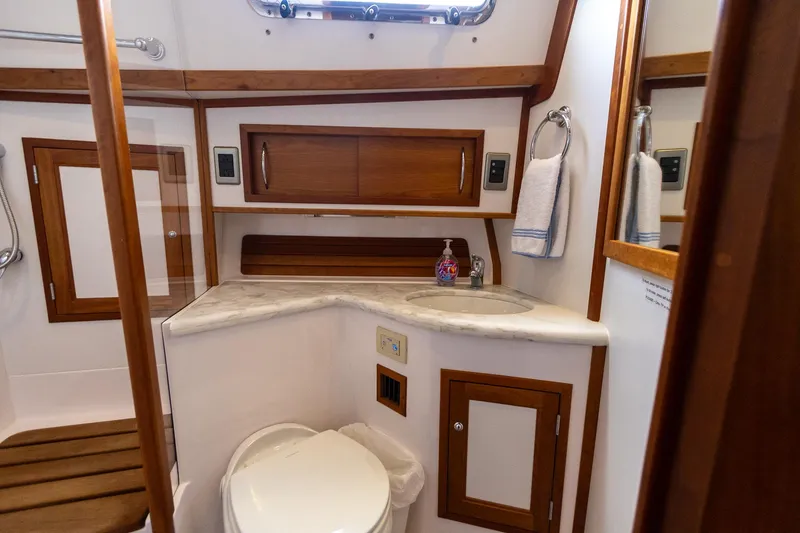 Slide: The Image of 2009 Sabre 52 Express yacht bathroom with wooden cabinetry and modern fixtures. - 48