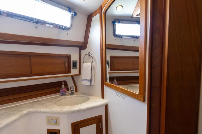 Slide: The Image of 2009 Sabre 52 Express yacht bathroom with wooden accents and marble countertop. - 49