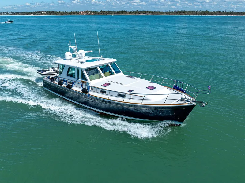 Slide: The Image of 2009 Sabre 52 Express yacht cruising on open water. - 5