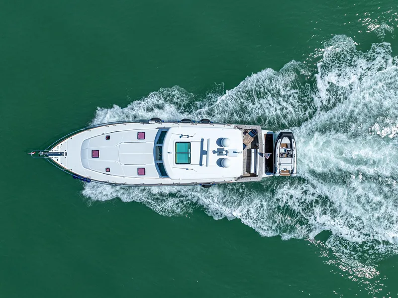 Slide: The Image of Aerial view of 2009 Sabre 52 Express yacht cruising on green water. - 7
