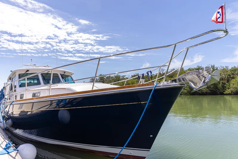 Slide: The Image of 2009 Sabre 52 Express yacht docked on a sunny day, featuring sleek design and blue hull. - 9
