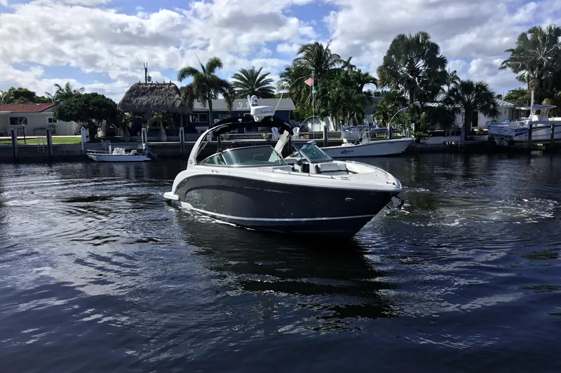 Slide: The Image of 2017 Regal 3200 Bowrider cruising on a sunny day near waterfront homes. - 11