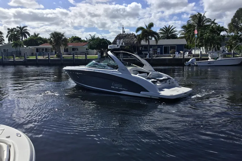 Slide: The Image of 2017 Regal 3200 Bowrider cruising on a sunny day near waterfront homes. - 17