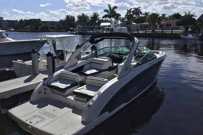 Slide: The Image of 2017 Regal 3200 Bowrider boat docked by a scenic waterfront with palm trees. - 20