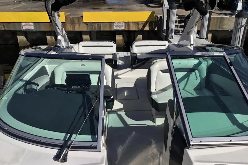 Slide: The Image of 2017 Regal 3200 Bowrider boat interior with seating and windshield at dock. - 23