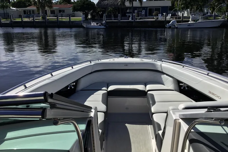 Slide: The Image of 2017 Regal 3200 Bowrider boat with spacious seating on calm water. - 24