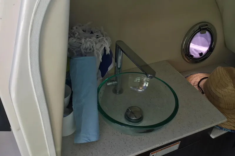 Slide: The Image of 2017 Regal 3200 Bowrider interior with glass sink and porthole window. - 28