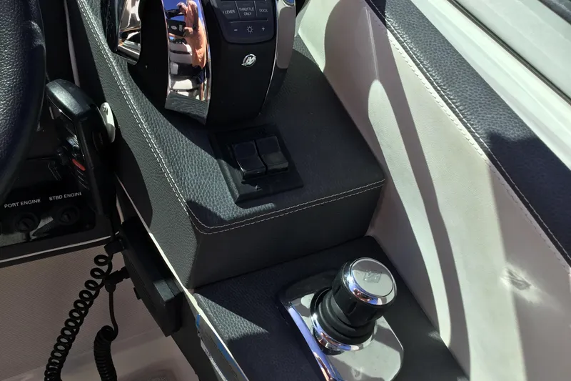 Slide: The Image of 2017 Regal 3200 Bowrider control panel with throttle and joystick. - 29