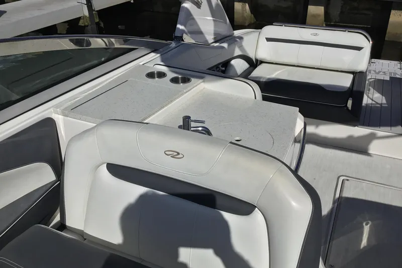 Slide: The Image of 2017 Regal 3200 Bowrider interior with white seating and built-in cup holders. - 32
