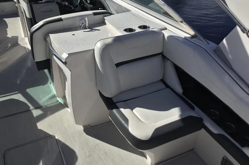 Slide: The Image of 2017 Regal 3200 Bowrider interior with white seating and built-in sink. - 35