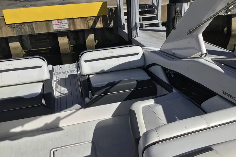 Slide: The Image of 2017 Regal 3200 Bowrider interior with white seating near dock. - 37