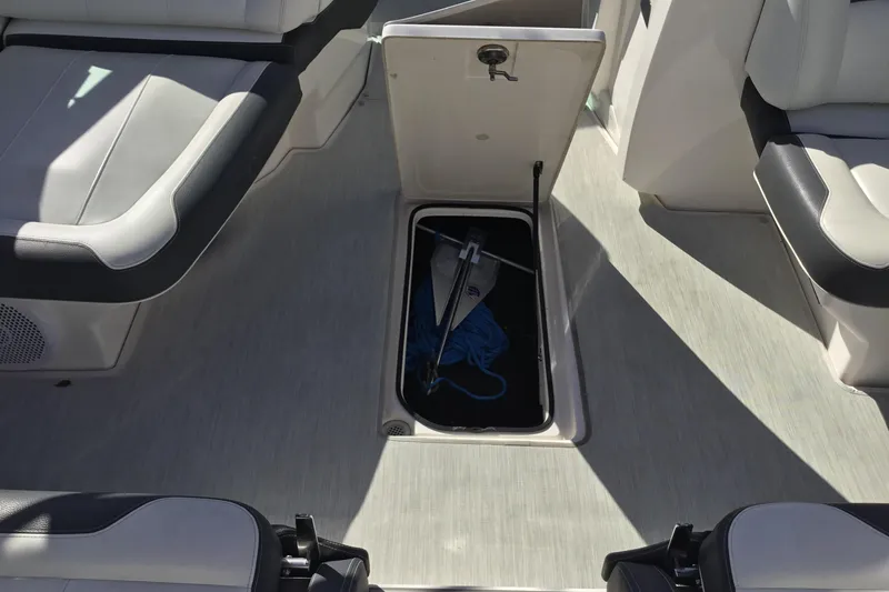 Slide: The Image of 2017 Regal 3200 Bowrider interior with open storage compartment and anchor. - 39