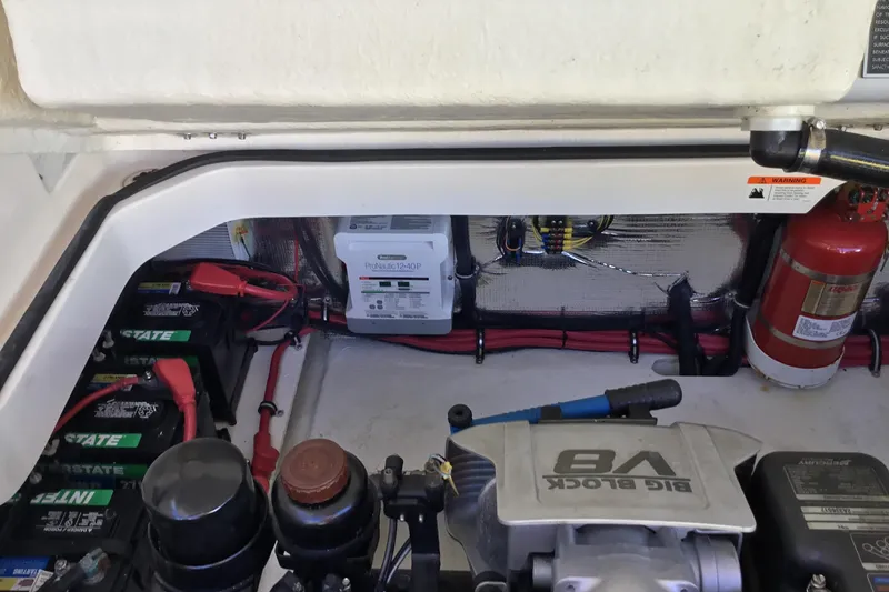 Slide: The Image of Engine compartment of a 2017 Regal 3200 Bowrider with batteries and fire extinguisher. - 51