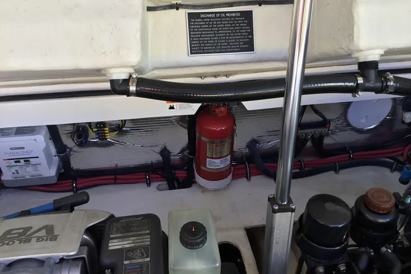 Slide: The Image of Engine compartment of a 2017 Regal 3200 Bowrider with visible fire extinguisher and wiring. - 52