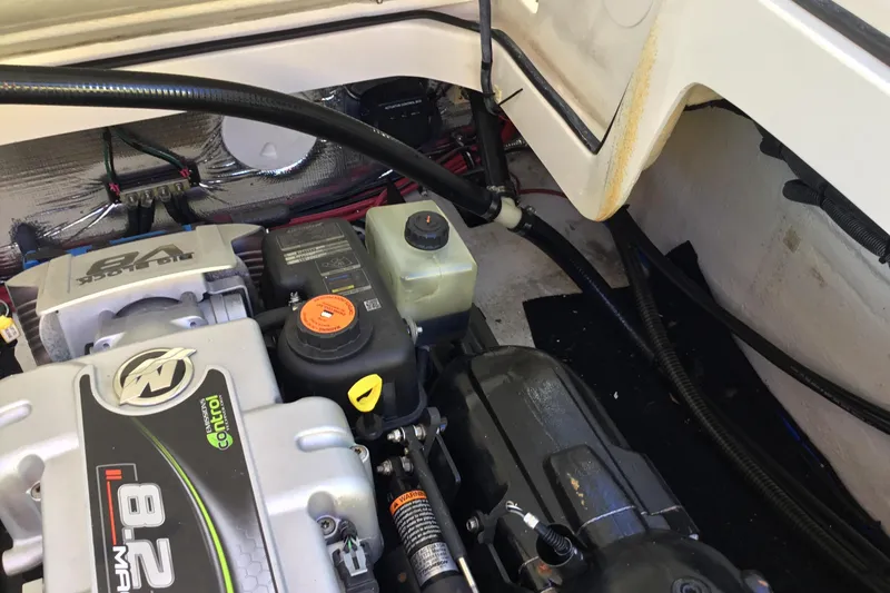 Slide: The Image of Engine compartment of a 2017 Regal 3200 Bowrider, showcasing mechanical components and wiring. - 53