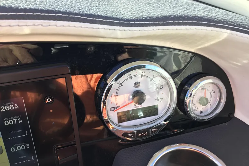 Slide: The Image of Dashboard of a 2017 Regal 3200 Bowrider boat with gauges and controls. - 58