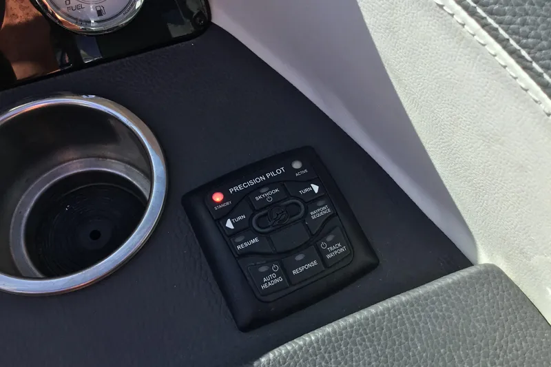 Slide: The Image of Control panel of a 2017 Regal 3200 Bowrider boat with cup holder. - 62