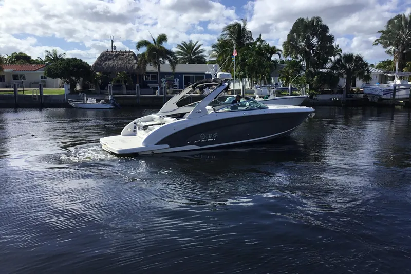 Slide: The Image of 2017 Regal 3200 Bowrider cruising on a sunny day near waterfront homes. - 7