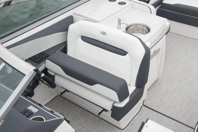 Slide: The Image of Manufacturer Provided Image: 2017 Regal 3200 Bowrider cockpit with white and black seating, sink, and control panel. - 74