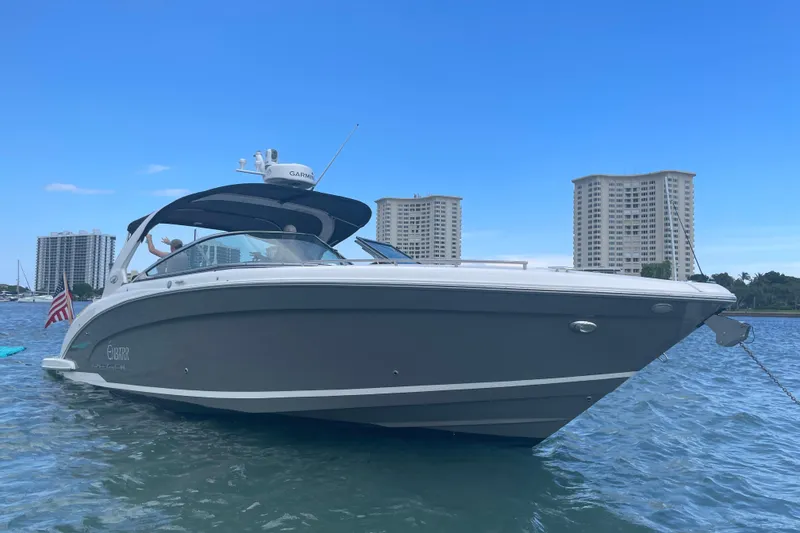 Slide: The Image of 2017 Regal 3200 Bowrider boat on water with city skyline background. - 78