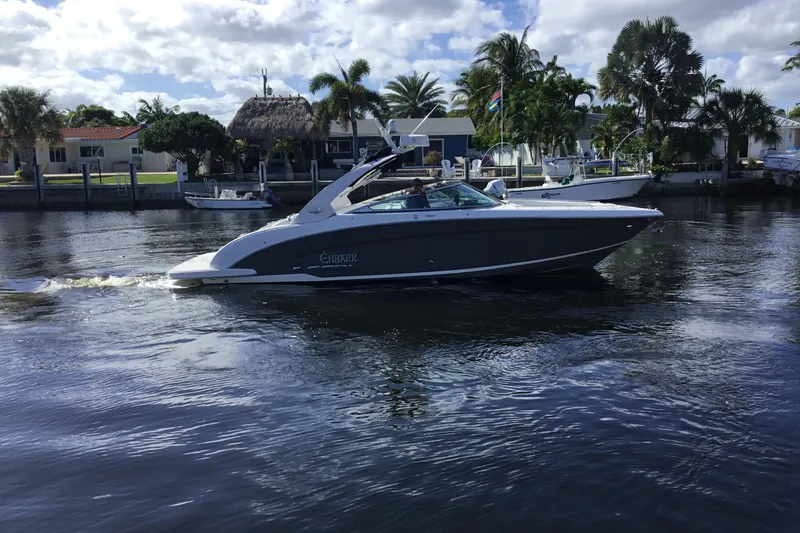 Slide: The Image of 2017 Regal 3200 Bowrider cruising on a sunny day near waterfront homes. - 8