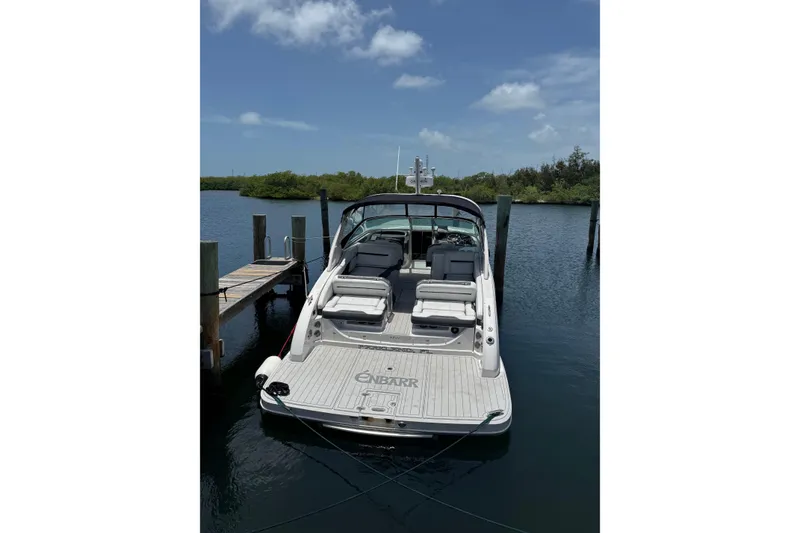 Slide: The Image of 2017 Regal 3200 Bowrider docked on calm water under a clear sky. - 82