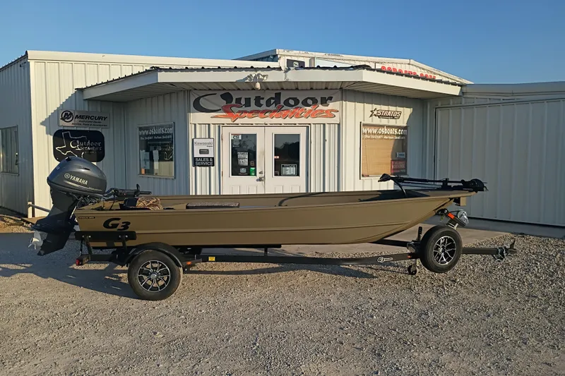 The Image of 2026 G3 Gator Tough 16 FL boat on trailer outside Outdoor Specialties store. - 1