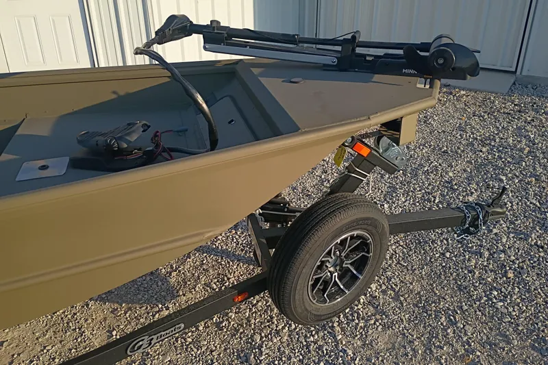 Slide: The Image of 2026 G3 Gator Tough 16 FL boat on trailer, gravel background. - 3