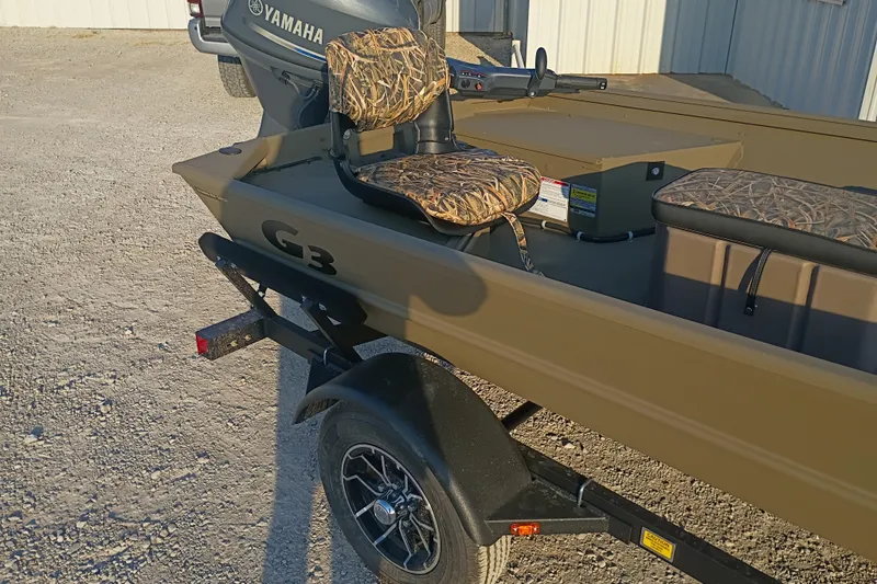 Slide: The Image of 2026 G3 Gator Tough 16 FL boat with Yamaha motor and camo seats on trailer. - 6