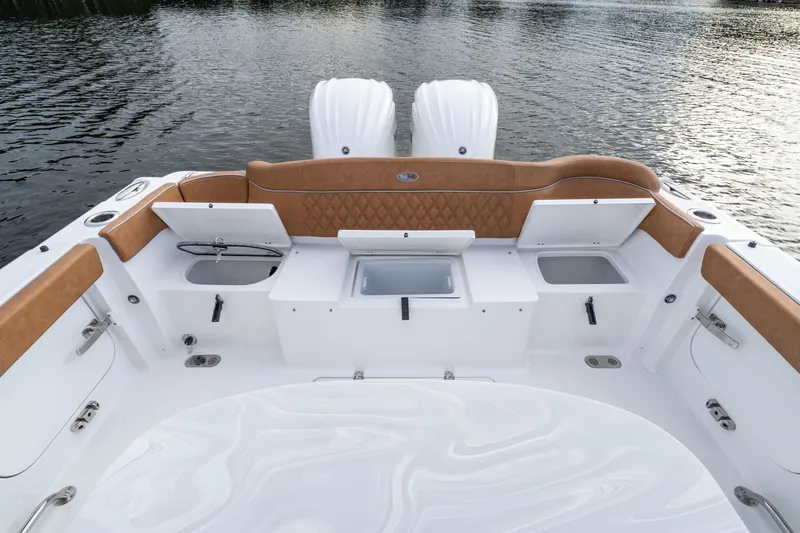 Slide: The Image of 2026 Sea Hunt Ultra 285 SE boat interior with storage compartments and twin engines. - 15