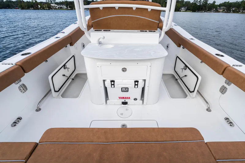 Slide: The Image of 2026 Sea Hunt Ultra 285 SE boat interior with seating, storage, and Yamaha cooler. - 16