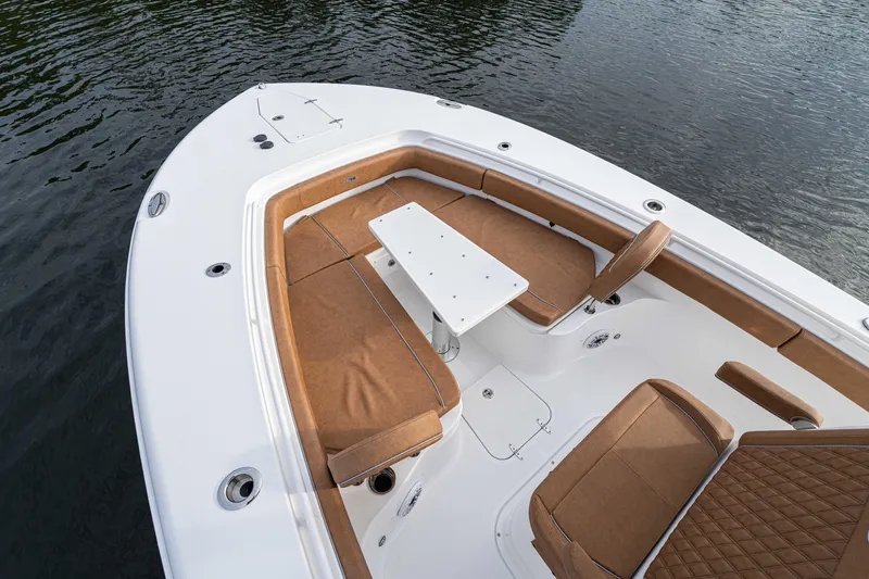 Slide: The Image of 2026 Sea Hunt Ultra 285 SE boat interior with brown seating and white table. - 7