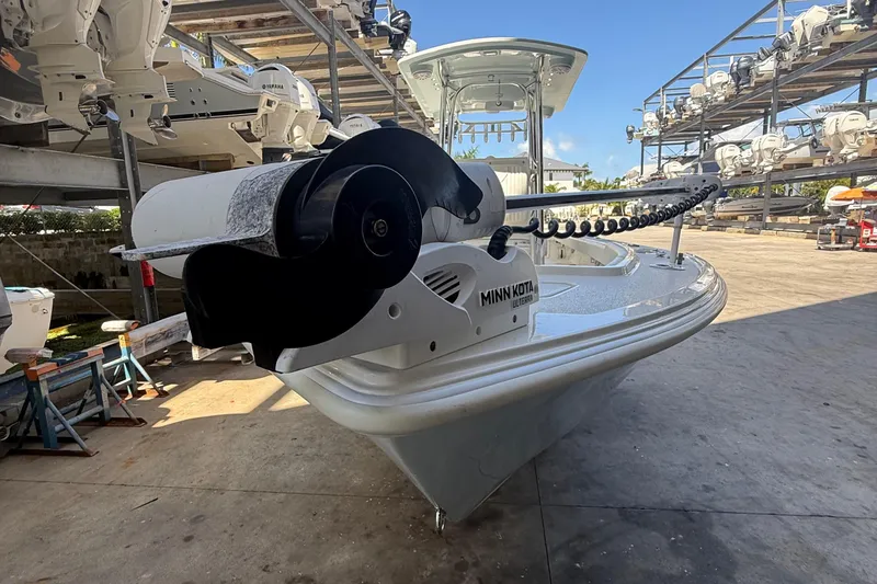 Slide: The Image of 2022 Dorado 25 Flat Deck boat with Minn Kota trolling motor in storage facility. - 12