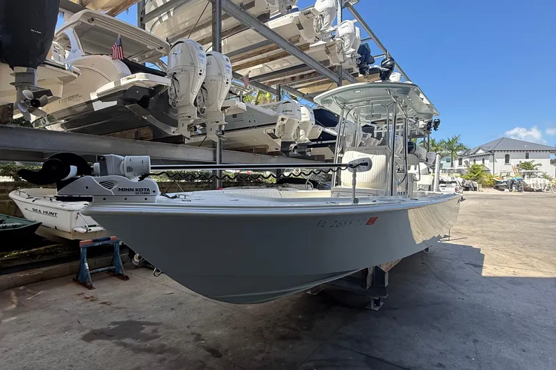 Slide: The Image of 2022 Dorado 25 Flat Deck boat in storage, featuring Minn Kota trolling motor. - 13