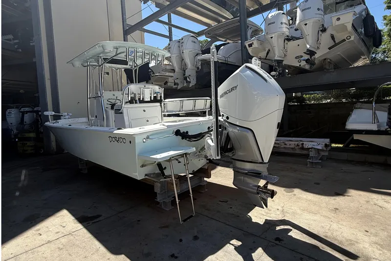Slide: The Image of 2022 Dorado 25 Flat Deck boat with Mercury outboard engine in storage facility. - 2