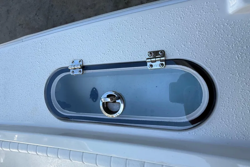 Slide: The Image of Dorado 25 Flat Deck 2022 boat hatch with secure latch and textured surface. - 22
